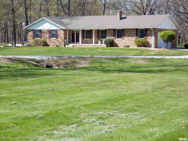 1723 Walnut Hill Rd, Centralia, IL 62801 - ranch-style house featuring a chimney, brick siding, a front lawn, and covered porch