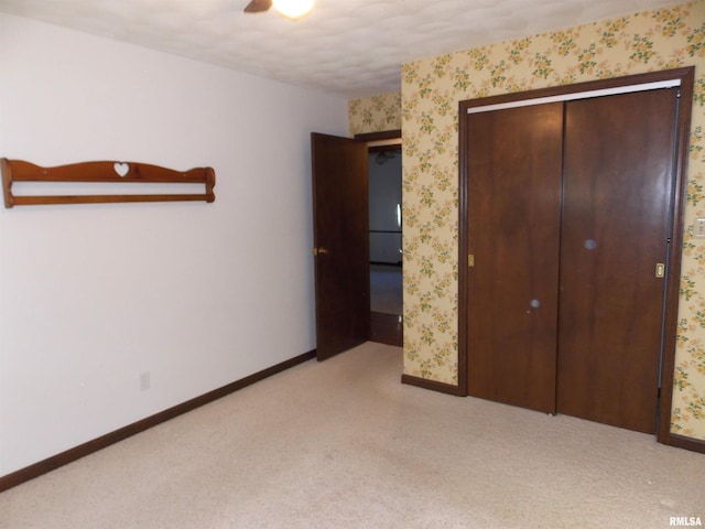 1723 Walnut Hill Rd, Centralia, IL 62801 - unfurnished bedroom featuring light colored carpet, wallpapered walls, a closet, and a ceiling fan