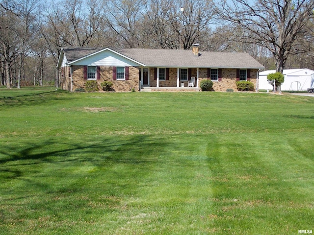 1723 Walnut Hill Rd, Centralia, IL 62801 - single story home featuring a porch, brick siding, a front yard, and a chimney