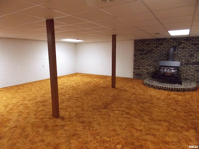 1723 Walnut Hill Rd, Centralia, IL 62801 - finished below grade area featuring a drop ceiling, a wood stove, carpet, and brick wall