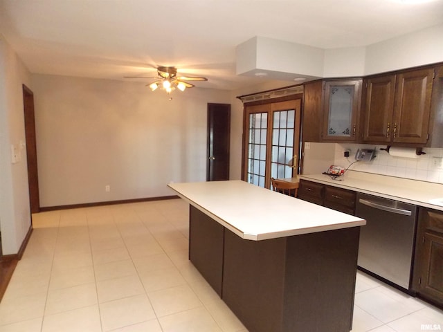 1723 Walnut Hill Rd, Centralia, IL 62801 - kitchen with stainless steel dishwasher, a kitchen island, light countertops, dark brown cabinetry, and a ceiling fan