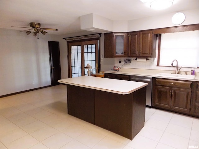 1723 Walnut Hill Rd, Centralia, IL 62801 - kitchen with stainless steel dishwasher, light countertops, a center island, a ceiling fan, and dark brown cabinets