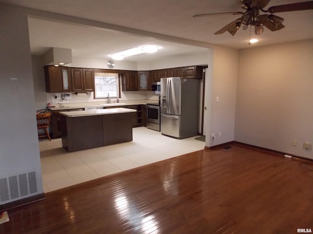 1723 Walnut Hill Rd, Centralia, IL 62801 - kitchen with stainless steel appliances, dark brown cabinets, ceiling fan, light countertops, and light wood-style flooring