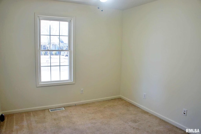 carpeted spare room with a wealth of natural light