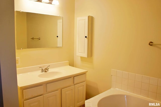 bathroom with vanity and a tub to relax in