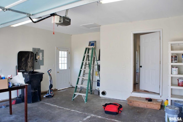 garage with a garage door opener and electric panel