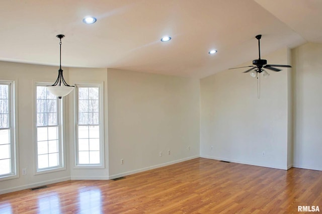 unfurnished room with vaulted ceiling, ceiling fan, and light hardwood / wood-style floors