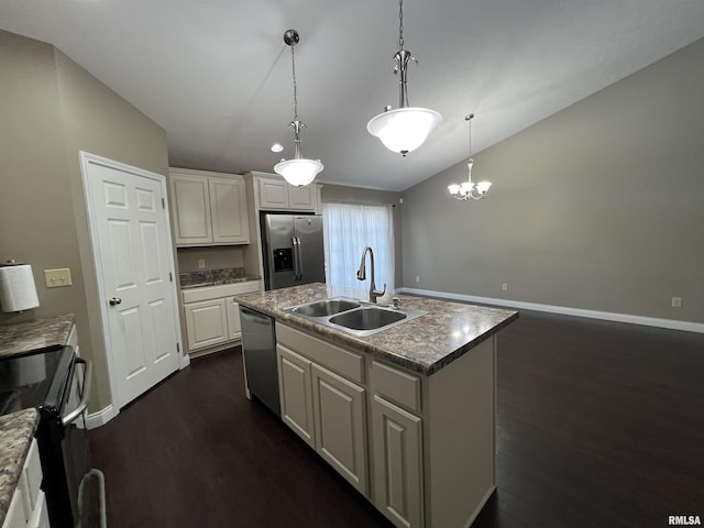 kitchen with decorative light fixtures, white cabinetry, sink, stainless steel appliances, and a center island with sink