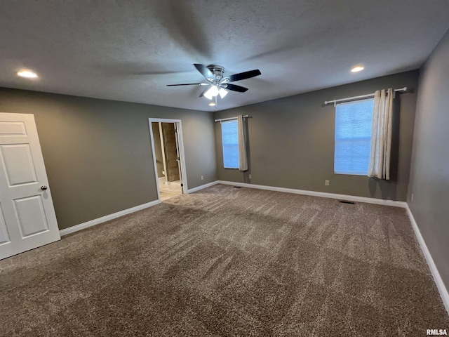 unfurnished room with a textured ceiling, carpet floors, and ceiling fan