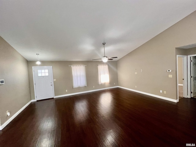 interior space with ceiling fan, lofted ceiling, and dark hardwood / wood-style flooring