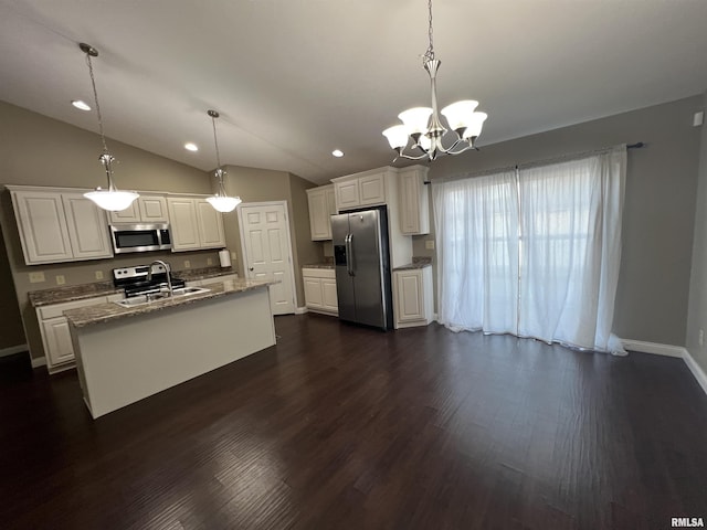 kitchen with stainless steel appliances, a kitchen island with sink, pendant lighting, and white cabinets