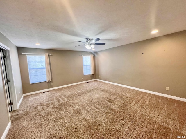 unfurnished room with carpet floors, a textured ceiling, and ceiling fan