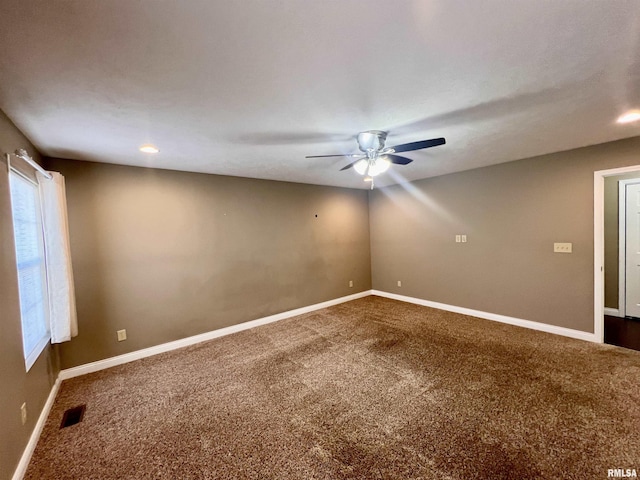 carpeted spare room featuring ceiling fan