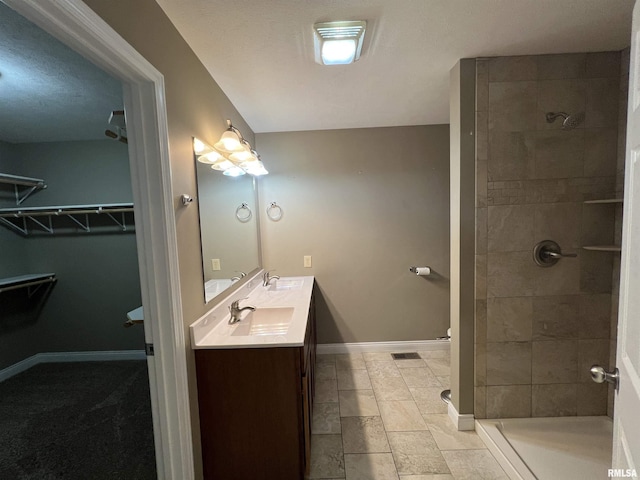 bathroom featuring vanity and tiled shower