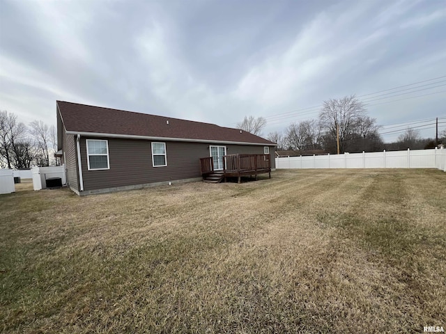 rear view of property with a lawn and a deck