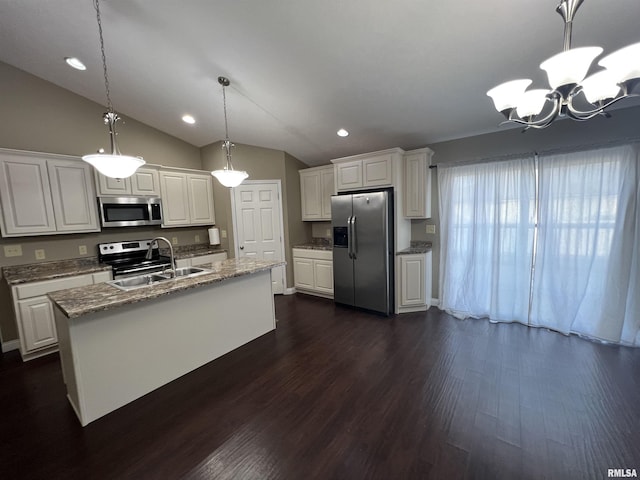 kitchen featuring white cabinetry, appliances with stainless steel finishes, decorative light fixtures, and sink