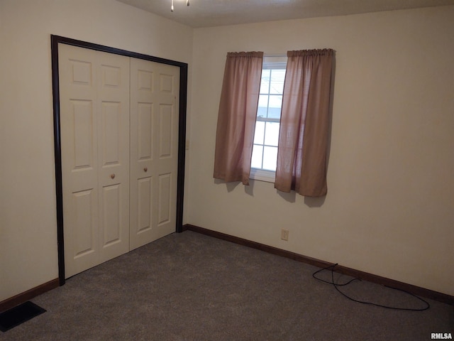 8027 Shawnee College Rd, Ullin, IL 62992 - unfurnished bedroom with dark colored carpet, baseboards, and a closet
