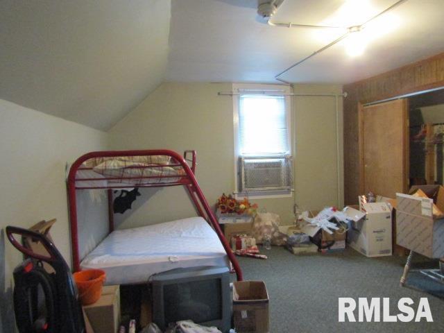 602 4th St, Rosiclare, IL 62982 - bedroom with lofted ceiling, carpet floors, and cooling unit