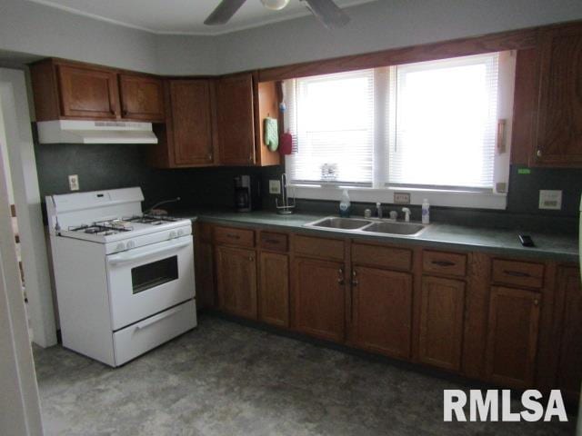 602 4th St, Rosiclare, IL 62982 - kitchen with white gas range, plenty of natural light, sink, and ceiling fan