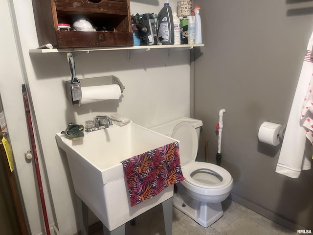 bathroom featuring tile patterned flooring and toilet