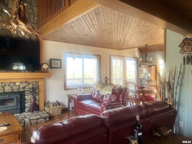 living room with wood ceiling, wood-type flooring, a fireplace, and an inviting chandelier