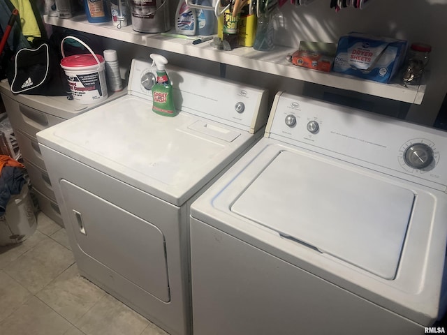 clothes washing area featuring separate washer and dryer and light tile patterned floors