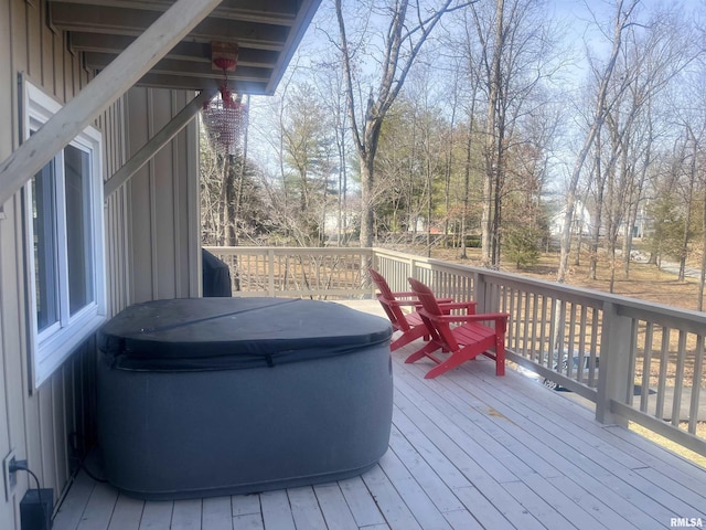 wooden deck with a hot tub