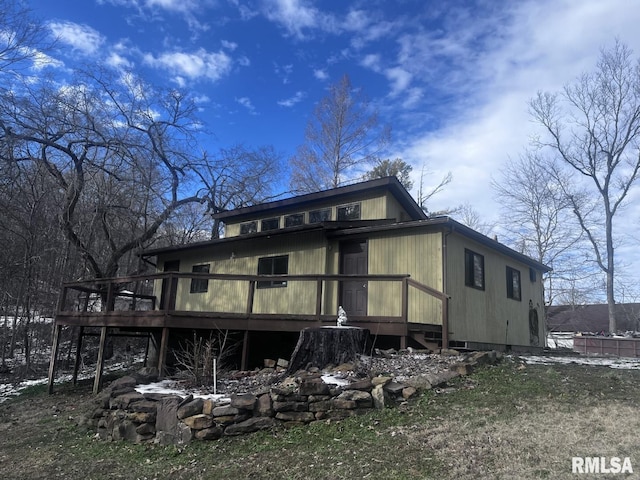 rear view of house featuring a deck