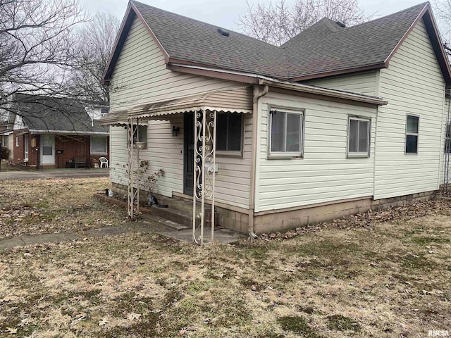 view of side of home with a yard