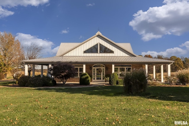 rear view of property with a lawn