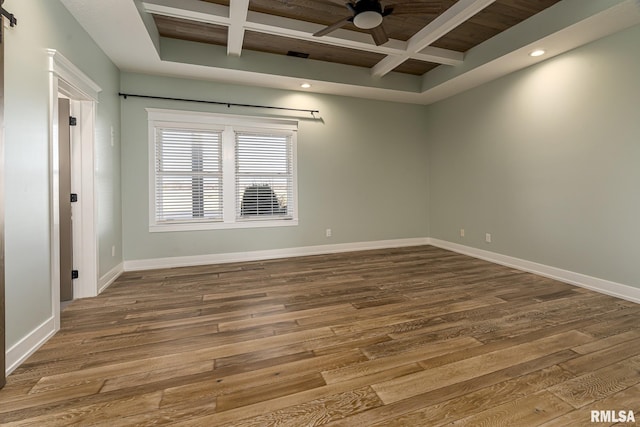 empty room featuring coffered ceiling, hardwood / wood-style flooring, and ceiling fan