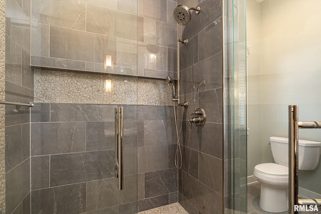 bathroom featuring walk in shower and toilet