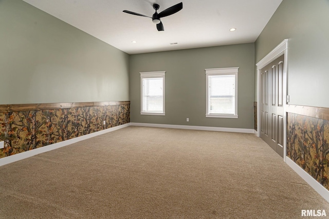 empty room featuring light carpet and ceiling fan