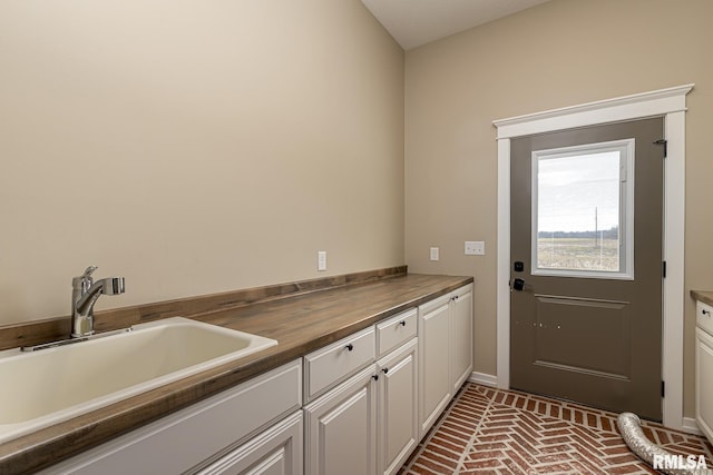 clothes washing area with sink