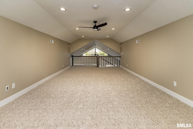 bonus room featuring lofted ceiling, light carpet, and ceiling fan