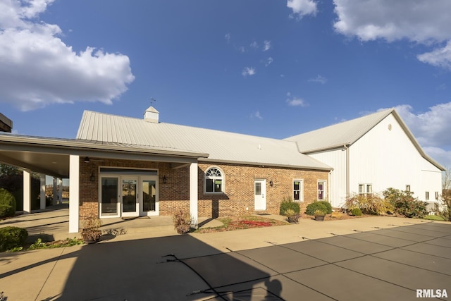 back of house featuring a carport and french doors