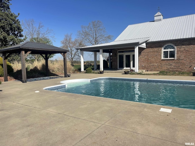 pool with a patio, a gazebo, and french doors