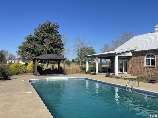 outdoor pool with a gazebo and a patio