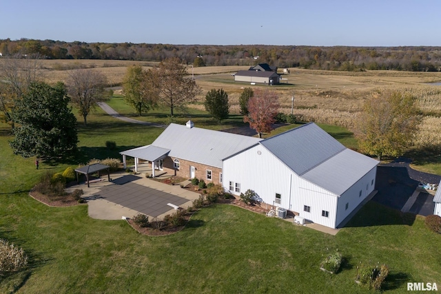 birds eye view of property with a rural view