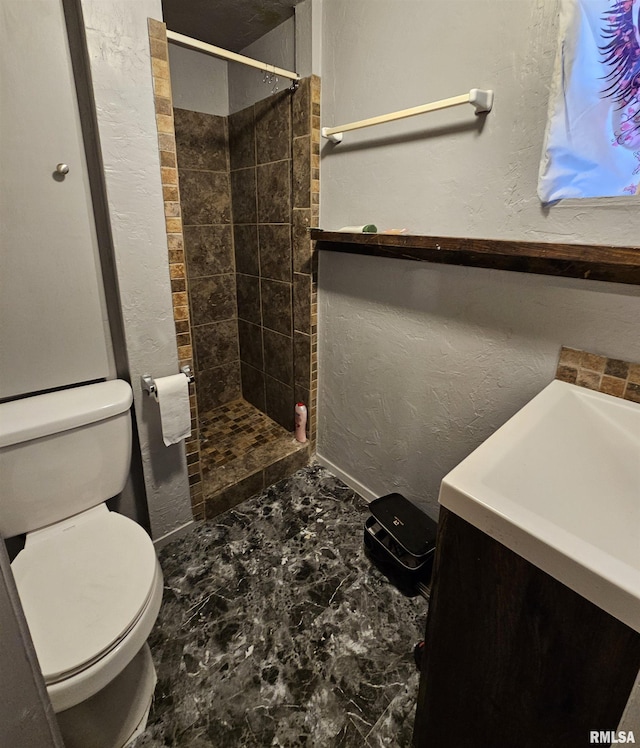 bathroom with tiled shower and toilet