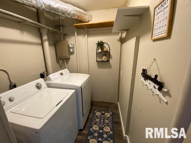 clothes washing area with dark hardwood / wood-style floors and independent washer and dryer