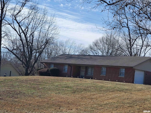 ranch-style house featuring a garage and a front yard