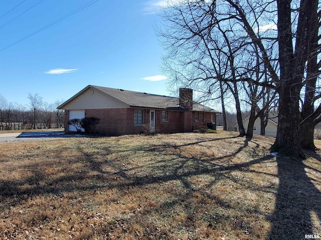 view of home's exterior with a garage and a yard