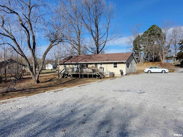 rear view of house featuring a wooden deck and central AC unit