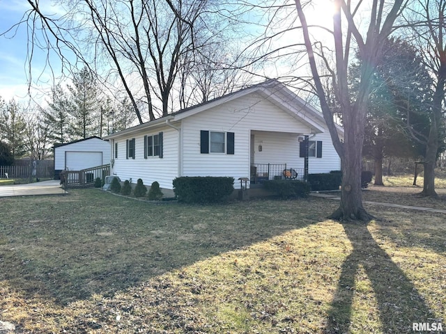 single story home with a garage, an outdoor structure, and a front lawn