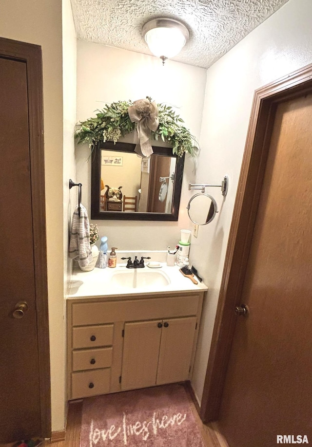 bathroom featuring vanity and a textured ceiling