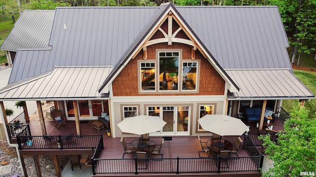 rear view of property with a wooden deck