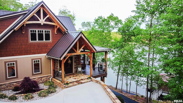 view of front of house with a porch and a water view