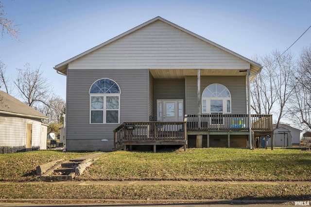 back of property featuring a yard and a deck