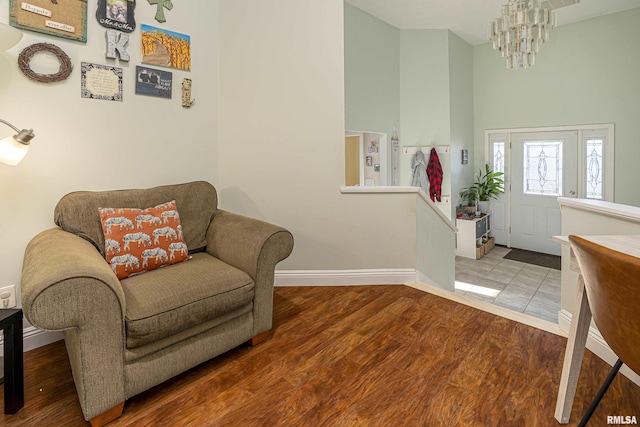 foyer with hardwood / wood-style flooring and a notable chandelier